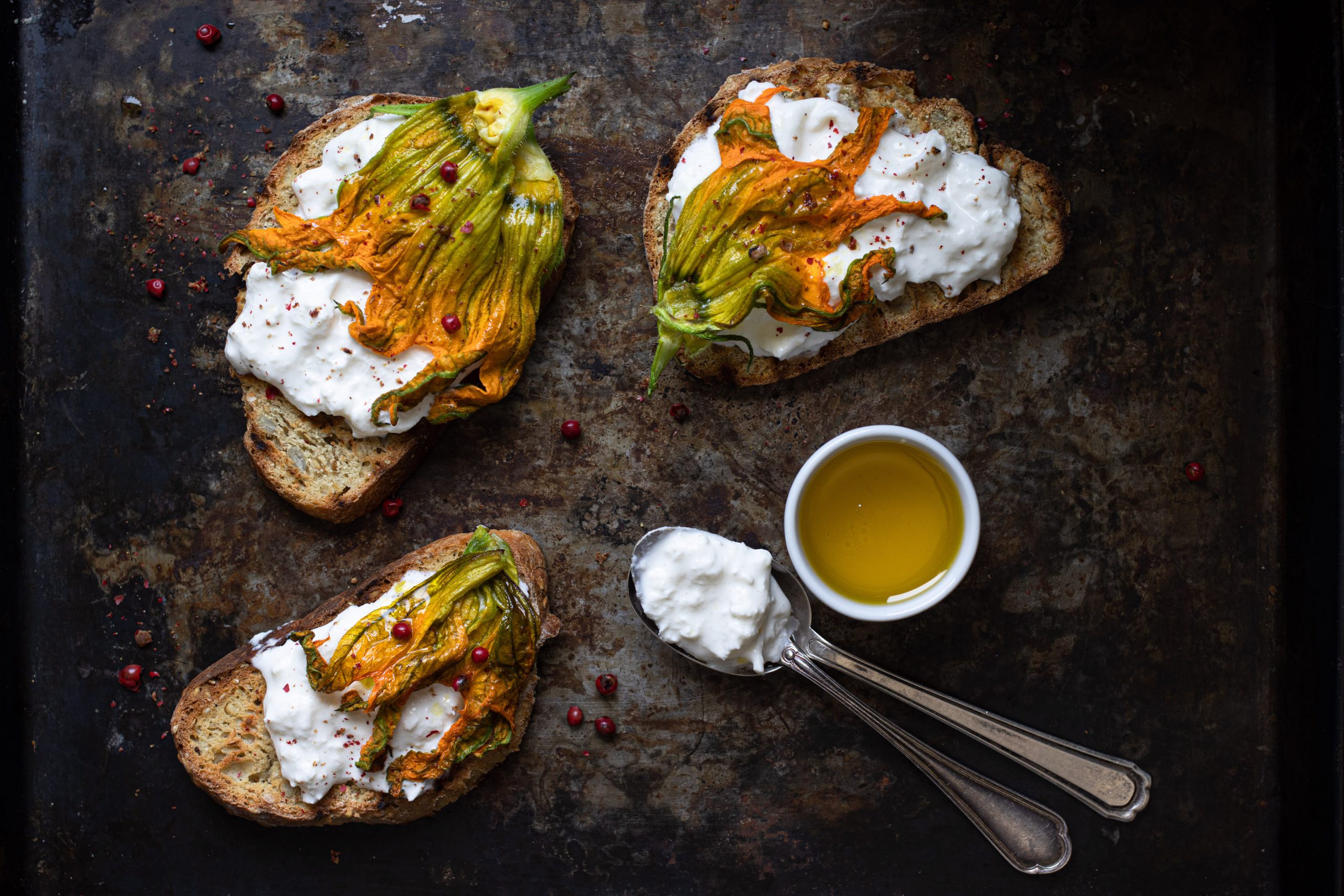 Crostoni burrata, fiori di zucca e pepe rosa